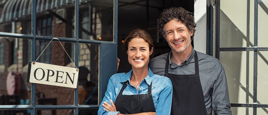 Business owners standing outside of their business