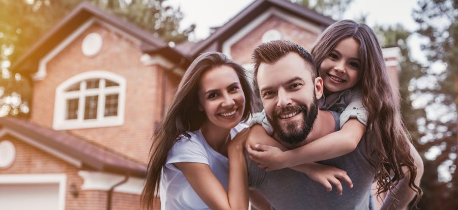 Family huddled in front of home