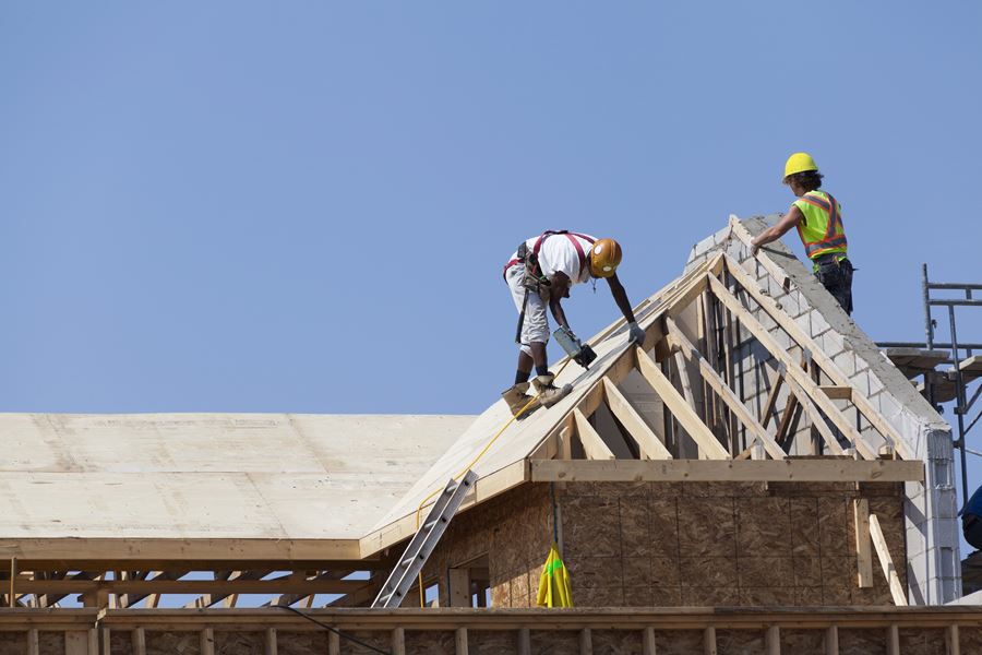 Construction workers working on roof